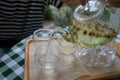 Pouring Chamomile tea from teapot into cup