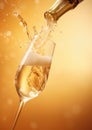 Pouring champagne from bottle in to glasses with splash on golden background