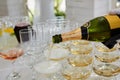 Pouring champagne in flutes standing on table Royalty Free Stock Photo