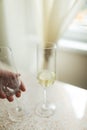 Pouring champagne in flutes standing on table Royalty Free Stock Photo