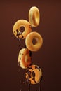 Pouring chocolate on doughnuts on brown background. 3d render