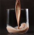 Pouring chocolate milk Royalty Free Stock Photo