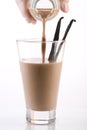 Pouring chocolate milk Royalty Free Stock Photo