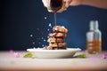 pouring chocolate sauce on a stack of mini pancakes Royalty Free Stock Photo