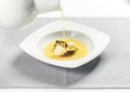 Pouring clear soup Royalty Free Stock Photo
