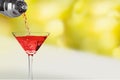 Pouring martini cocktail on blurred background Royalty Free Stock Photo