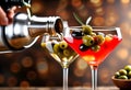 Pouring cocktail into martini glass with olives on blurred background, closeup Royalty Free Stock Photo