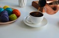 Pouring coffee into a cup from a turkish coffee pot, multicolored macaroons on white background Royalty Free Stock Photo