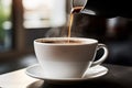 Pouring coffee streaming fresh white cup of hot aroma cappuccino americano espresso latte steam smoke on table morning Royalty Free Stock Photo