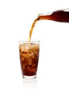 Pouring cola from bottle into glass with foam Royalty Free Stock Photo