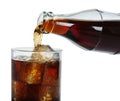 Pouring cola from bottle into glass with ice cubes on white background, closeup. Refreshing soda water Royalty Free Stock Photo