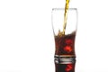 Pouring cola into glass with ice on white background Copy space Royalty Free Stock Photo