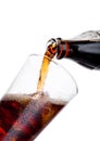 Pouring cola soda drink from bottle to glass Royalty Free Stock Photo