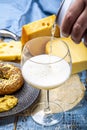 Pouring of cold belgian beer in glass, served in cafe with variety of hard cheeses, tasty european food Royalty Free Stock Photo