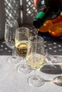 Pouring of cold fino sherry fortified wine in glass in sunlights, andalusian style interior on background Royalty Free Stock Photo