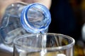 Pouring cold water from a bottle into a glass