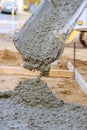 Pouring concrete with a cement mixer truck construction in the sidewalk Royalty Free Stock Photo