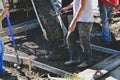 Pouring concrete material for new sidewalk. Royalty Free Stock Photo