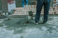 Pouring concrete with worker mix cement at construction site Royalty Free Stock Photo