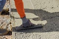 After pouring concrete worker uses a trowel to plaster the wet concrete cement floor Royalty Free Stock Photo