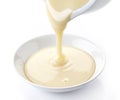 Pouring condensed milk Royalty Free Stock Photo
