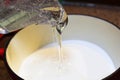 Pouring Corn Syrup into a Pot to Make Hard Candy