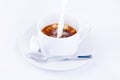 Pouring cream into a cup of coffee Royalty Free Stock Photo
