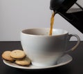 Pouring a cup of coffee with milanos Royalty Free Stock Photo