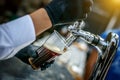 Pouring dark beer to plastic glass from beer tap. Royalty Free Stock Photo