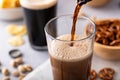 Pouring dark stout beer in a tall glass