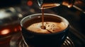 pouring delicious espresso in cup of coffee with rising steam