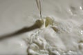 Pouring delicious fresh milk as background, closeup