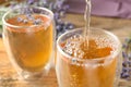 Pouring delicious lavender tea into glass