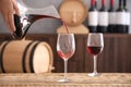 Pouring delicious red wine into glass Royalty Free Stock Photo