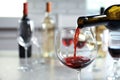 Pouring delicious red wine into glass on table Royalty Free Stock Photo