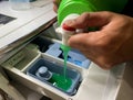 Pouring the detergent into the detergent slot of washing machine Royalty Free Stock Photo