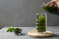 Pouring Detox Chlorella beverage in glass Royalty Free Stock Photo
