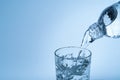 Pouring drinking water from plastic bottle into glass Royalty Free Stock Photo