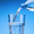 Pouring drinking water from plastic bottle into glass Royalty Free Stock Photo