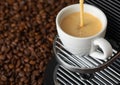 Pouring fresh morning coffee with espresso machine and sunlight and raw aroma beans Royalty Free Stock Photo