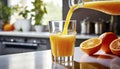 Pouring fresh orange juice into a glass with fresh fruits in background Royalty Free Stock Photo