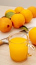 Pouring fresh orange juice. Squeezed orange parts on wooden board. Close up glass of fresh orange juice. Healthy and vegetarian Royalty Free Stock Photo