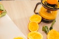 Pouring fresh orange juice. Squeezed orange parts on wooden board. Close up glass of fresh orange juice. Healthy and Royalty Free Stock Photo