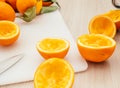 Pouring fresh orange juice. Squeezed orange parts on wooden board. Close up glass of fresh orange juice. Healthy and Royalty Free Stock Photo