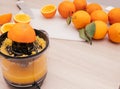 Pouring fresh orange juice. Squeezed orange parts on wooden board. Close up glass of fresh orange juice. Healthy and Royalty Free Stock Photo