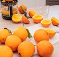 Pouring fresh orange juice. Squeezed orange parts on wooden board. Close up glass of fresh orange juice. Healthy and Royalty Free Stock Photo