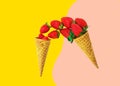 Pouring fresh ripe strawberries from waffle cones on duotone yellow pink background. Organic vegan sweets healthy diet