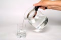 Pouring fresh mineral water from the jug into a glass Royalty Free Stock Photo