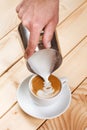 Pouring frothed milk into a cup of coffee, pattern creation Royalty Free Stock Photo