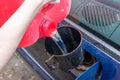 Pouring fuel with funnel in a car gas tank from red can Royalty Free Stock Photo